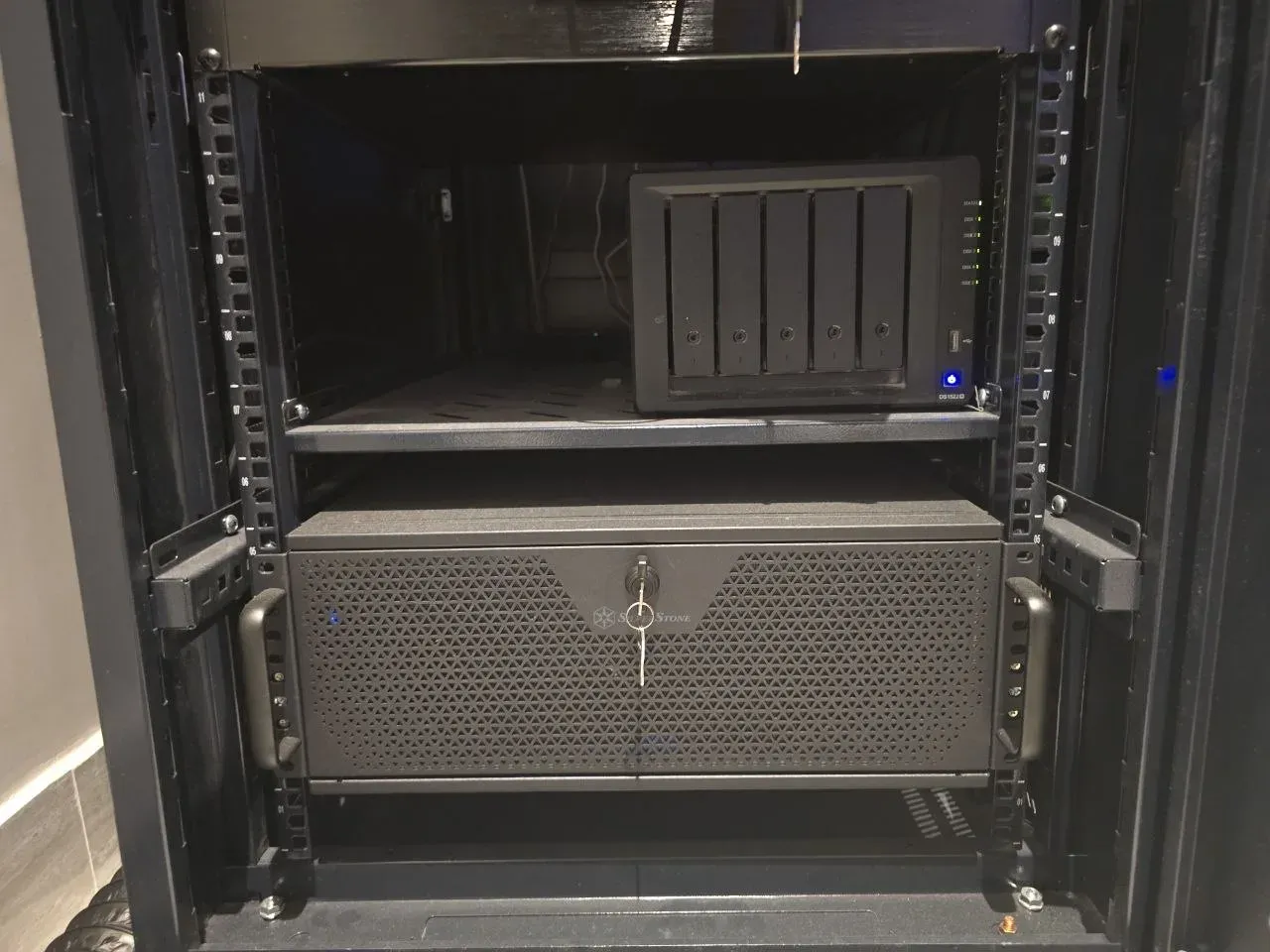 Synology DS1522+ NAS on a shelf above a Silverstone Proxmox server in the rack